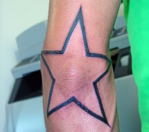 Star tattoo on elbow